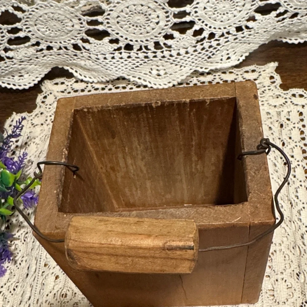 Wooden Container with a rooster holding Purple and Green Faux Flowers.